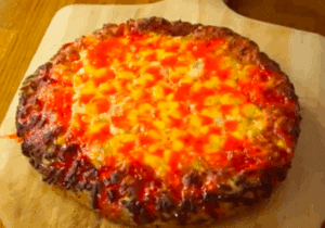 Just out of the oven pizza with melted candy corn topping.
