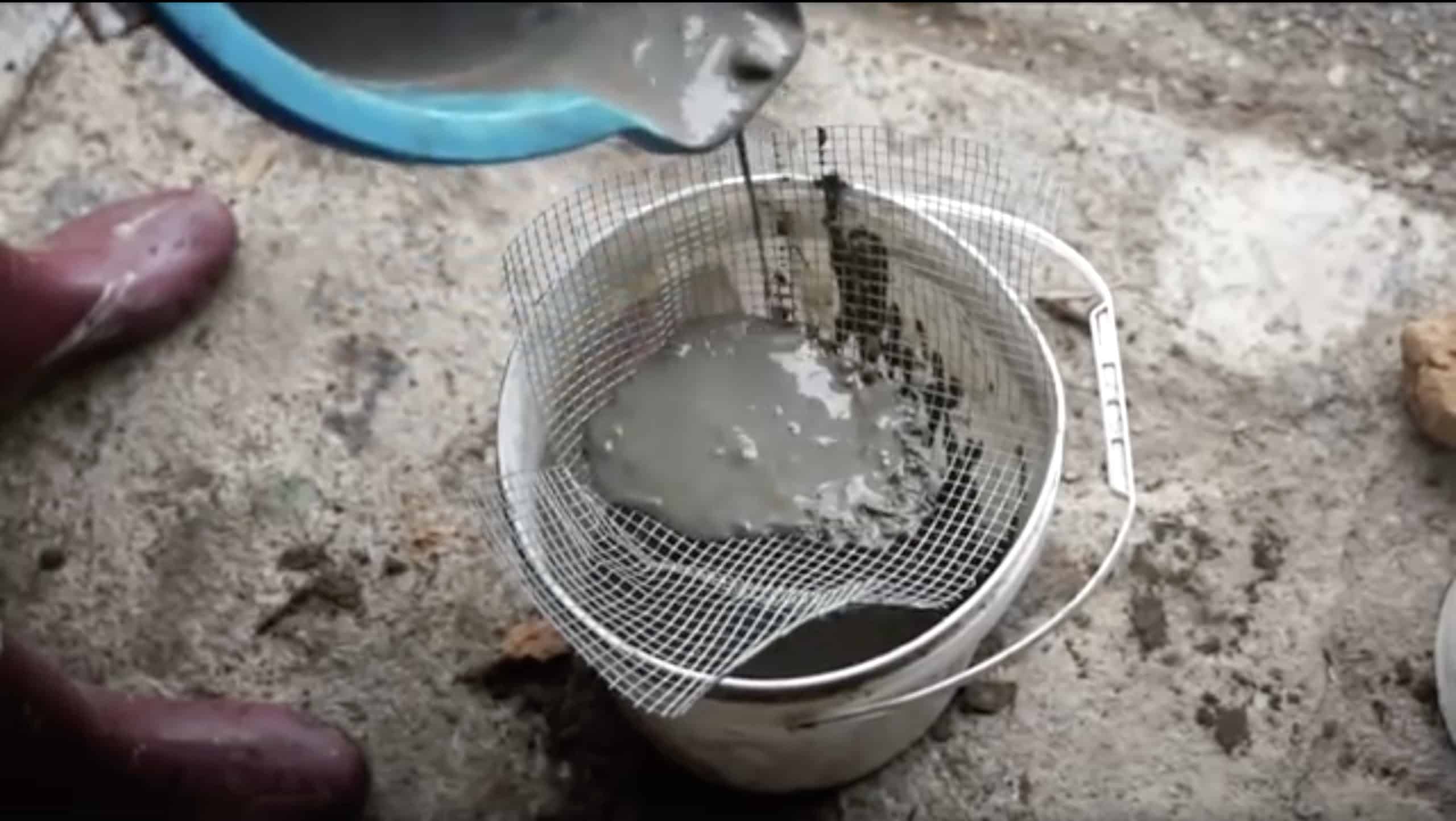 Pouring clay slurry through wire mesh. 