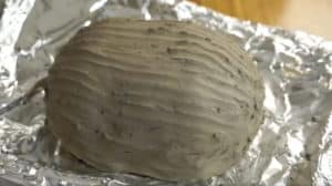 Clay wrapped chicken before being baked.