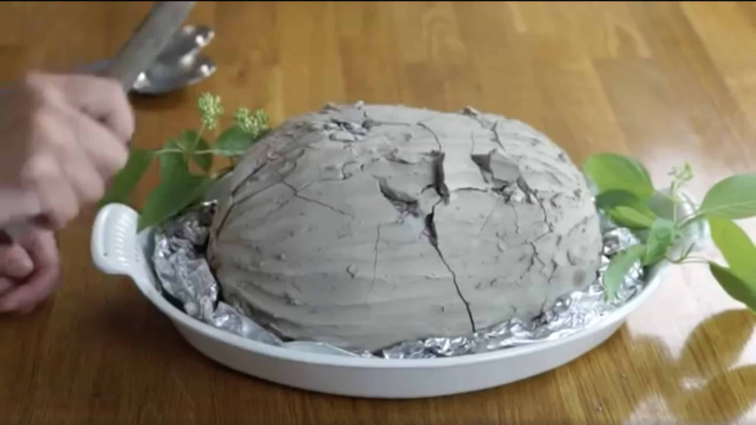 Beggar's chicken with cracked clay shell. 