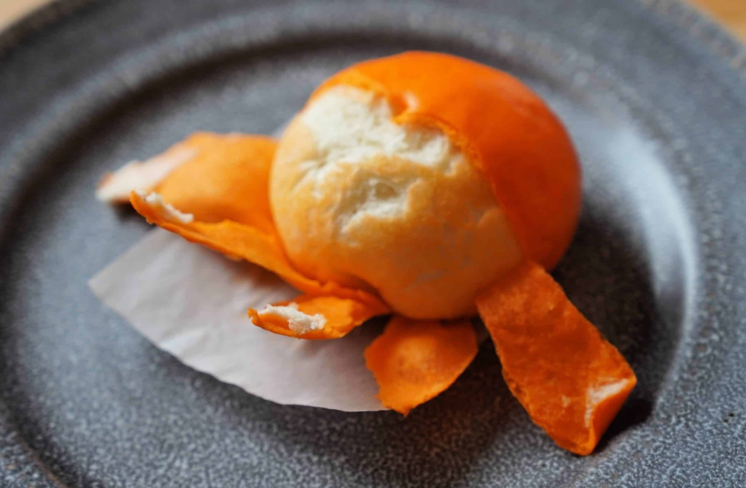 A tangerine bao with the skin peeled back. 