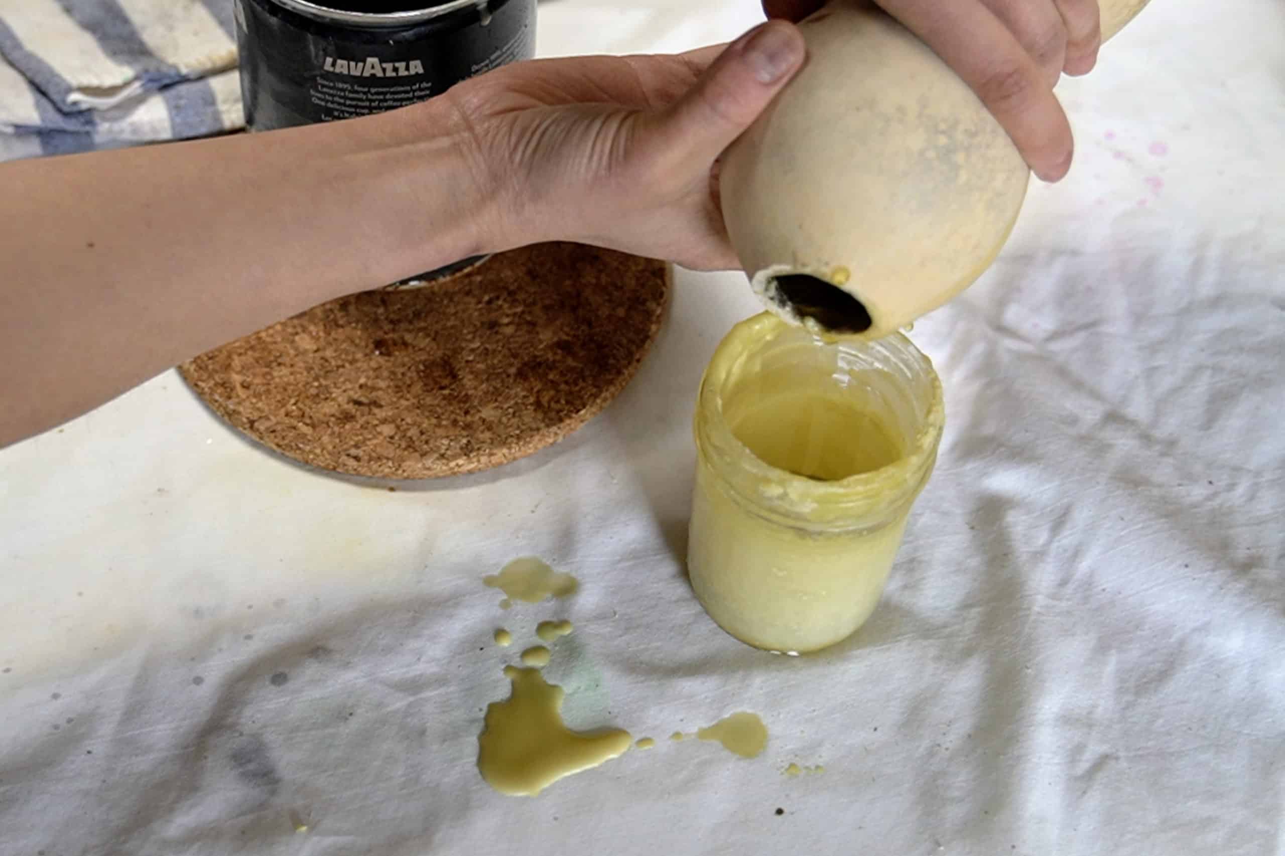 Pouring wax out of a bottle gourd. 