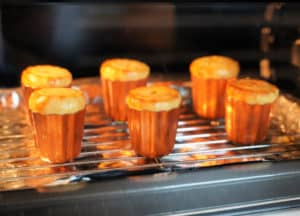 Canele puffing in the oven.