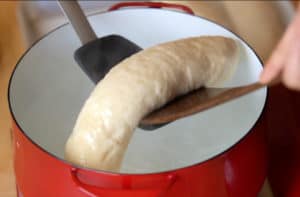 Taking boiled bread out of the water.