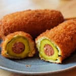 Pickle corn dog cut in cross section.