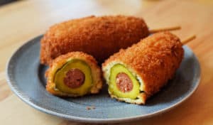 Pickle corn dog cut in cross section.