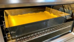 Gooey cake in the oven baking. Still yellow.
