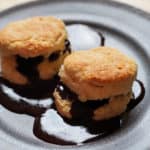 Biscuits with chocolate gravy on a grey plate.