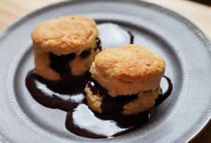 Biscuits with chocolate gravy on a grey plate.