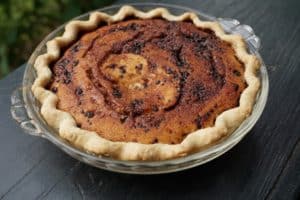 Pie with dark chocolate swirls and a light crust.