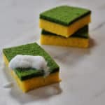 Cake that looks like dish sponges with yelllow bottom and green top with a soapy frosting.