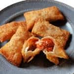 A grey plate with homemade Totino's pizza rolls.