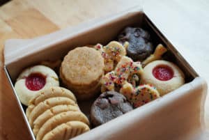 A tin filled with holiday cookies.