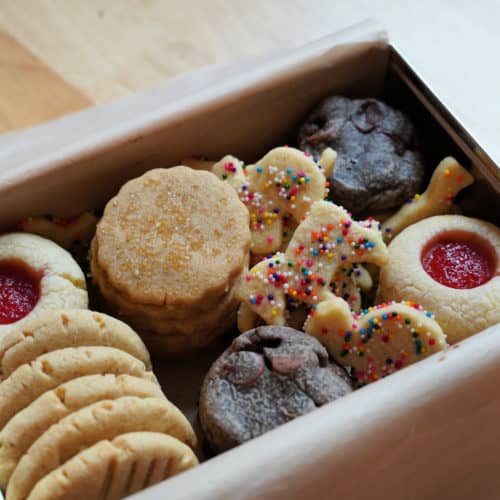 A tin filled with holiday cookies.