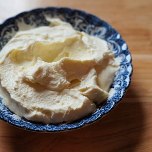 Homemade cream cheese in a blue and white dish.