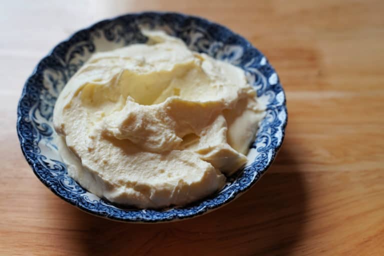 Homemade cream cheese in a blue and white dish.