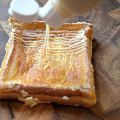 Milk toast on a wood cutting board drizzled with condensed milk condensed milk on a woo