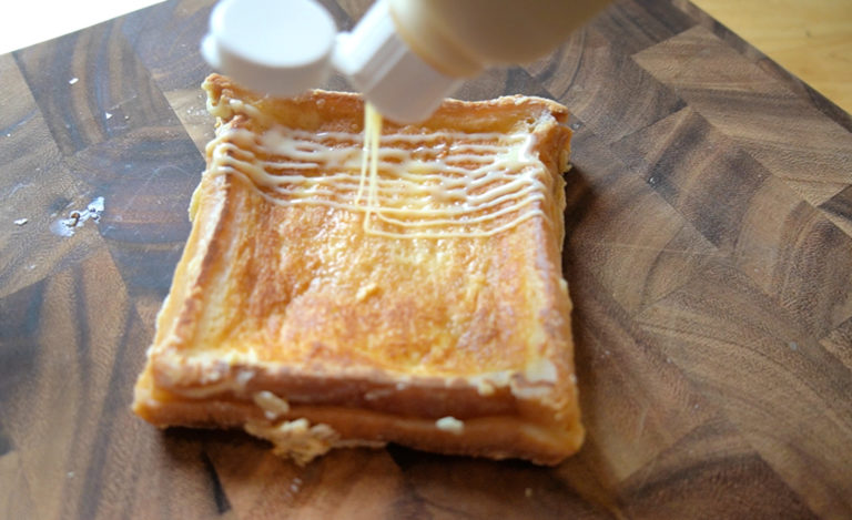 Milk toast on a wood cutting board drizzled with condensed milk condensed milk on a woo