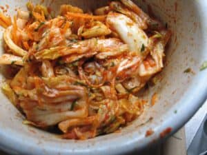 Napa cabbage cut up and mixed with spicy paste before fermenting.