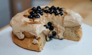 Beautiful sponge cake topped with milk tea-infused custard, and boba pearls. Slice of cake has been removed to show dripping boba lava.
