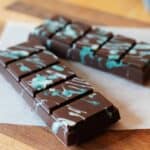 Two, five-sectioned chocolate bars with white/blue splatter pattern on top.