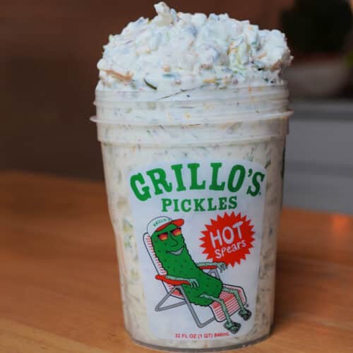 Gillo's pickle 32 oz cup with image of pickle in ballcap lazing about in a lawn chair. Pcikle cup overflowing with creamy pickle dip.