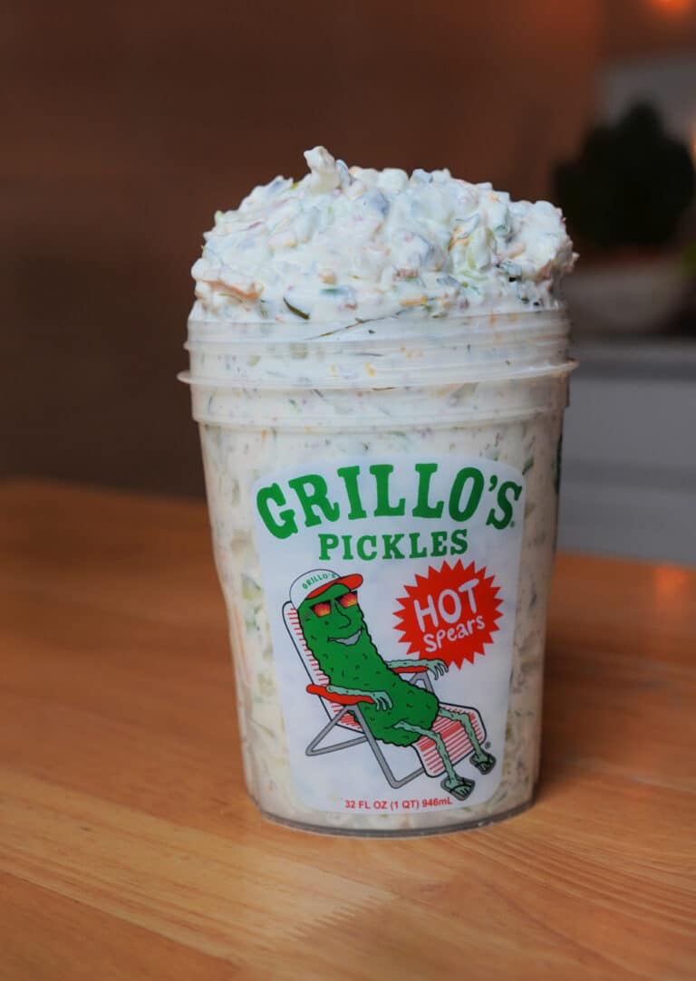 Gillo's pickle 32 oz cup with image of pickle in ballcap lazing about in a lawn chair. Pcikle cup overflowing with creamy pickle dip.