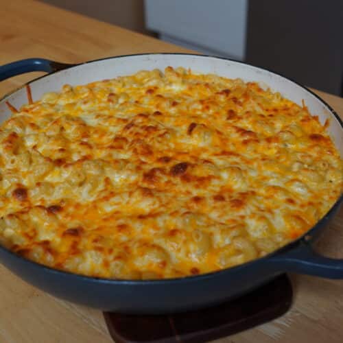 Finished Mac & Cheese in a round baking dish resting on the counter.