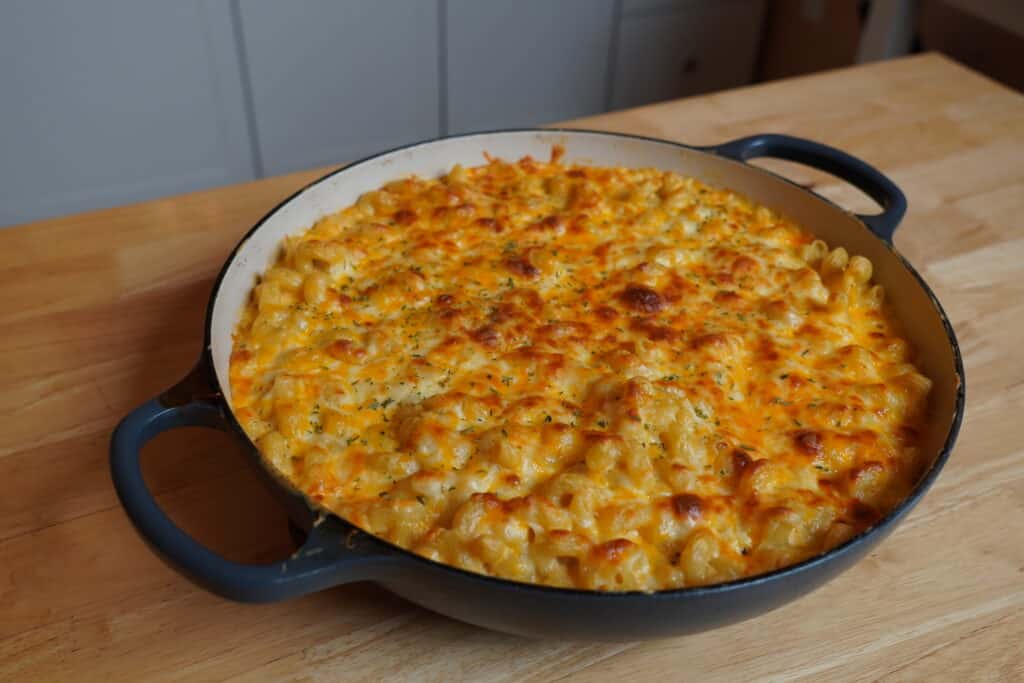 Bubbly, crispy Mac & Cheese in a round, ceramic baking dish.