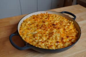 Bubbly, crispy Mac & Cheese in a round, ceramic baking dish.